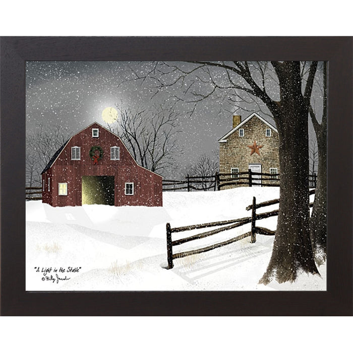 Black framed landscape Billy Jacobs wall art print of a red barn with a Christmas wreath and glowing door on a moonlit snowy night with a stone farmhouse and split rail fence titled "A Light in the Stable"
