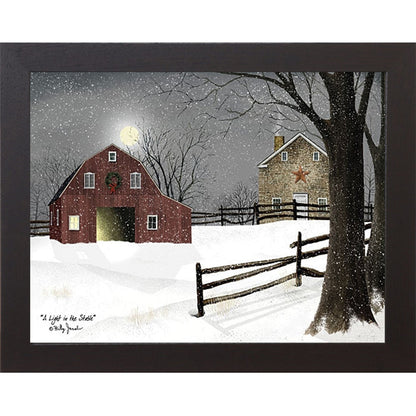 Black framed landscape Billy Jacobs wall art print of a red barn with a Christmas wreath and glowing door on a moonlit snowy night with a stone farmhouse and split rail fence titled "A Light in the Stable"