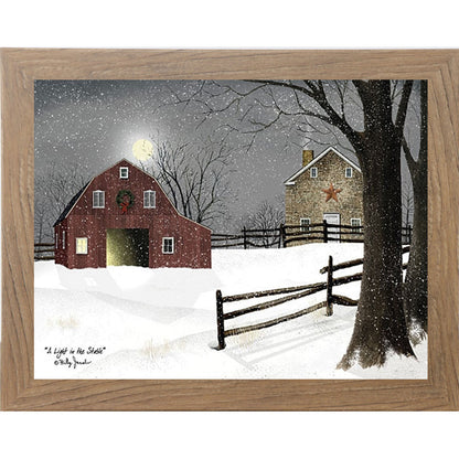 Farmtable framed landscape Billy Jacobs wall art print of a red barn with a Christmas wreath and glowing door on a moonlit snowy night with a stone farmhouse and split rail fence titled "A Light in the Stable"