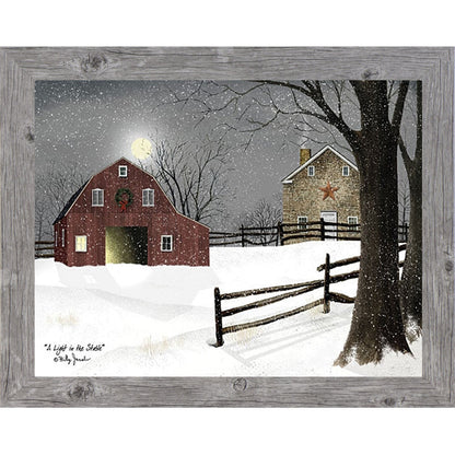 Gray framed landscape Billy Jacobs wall art print of a red barn with a Christmas wreath and glowing door on a moonlit snowy night with a stone farmhouse and split rail fence titled "A Light in the Stable"