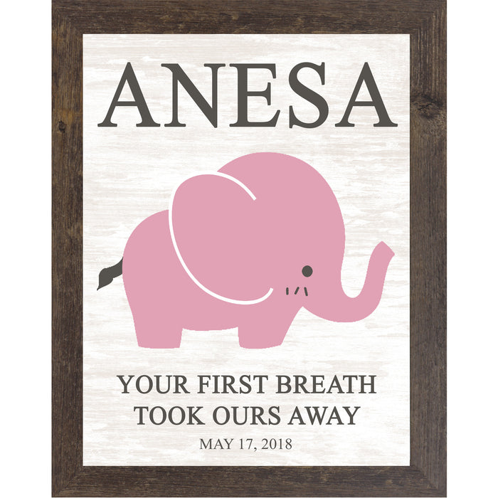 Natural brown framed personalized pink elephant nursery wall art with bold baby name at top and the words Your First Breath Took Ours Away with birth date on soft white shiplap background — PER149