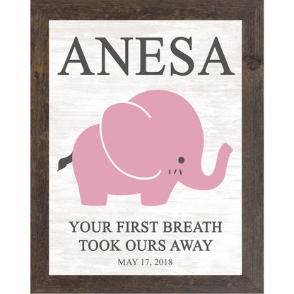 Natural brown framed personalized pink elephant nursery wall art with bold baby name at top and the words Your First Breath Took Ours Away with birth date on soft white shiplap background — PER149