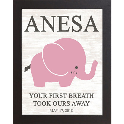 Black framed personalized pink elephant nursery wall art with bold baby name at top and the words Your First Breath Took Ours Away with birth date on soft white shiplap background — PER149